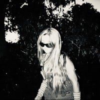 a black and white photo of a woman riding a skateboard