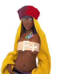 a black woman wearing a colorful sweater and hat