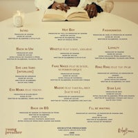 a poster with a woman sitting at a table reading a book