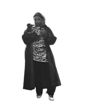 a black and white photo of a woman in a coat